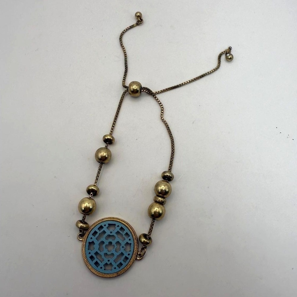 Gold Tone Adjustable Bracelet with‎ Blue Cutout Oval Medallion & Bead Accents